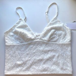 It’s a white shirt with a Lacey like pattern on it.